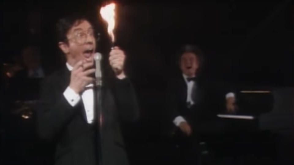 Martin Short as Jerry Lewis freaks out over a huge flame while Dave Thomas laughs in the background on SCTV.