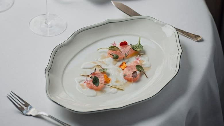 Plated dish with fork and knife on tablecloth