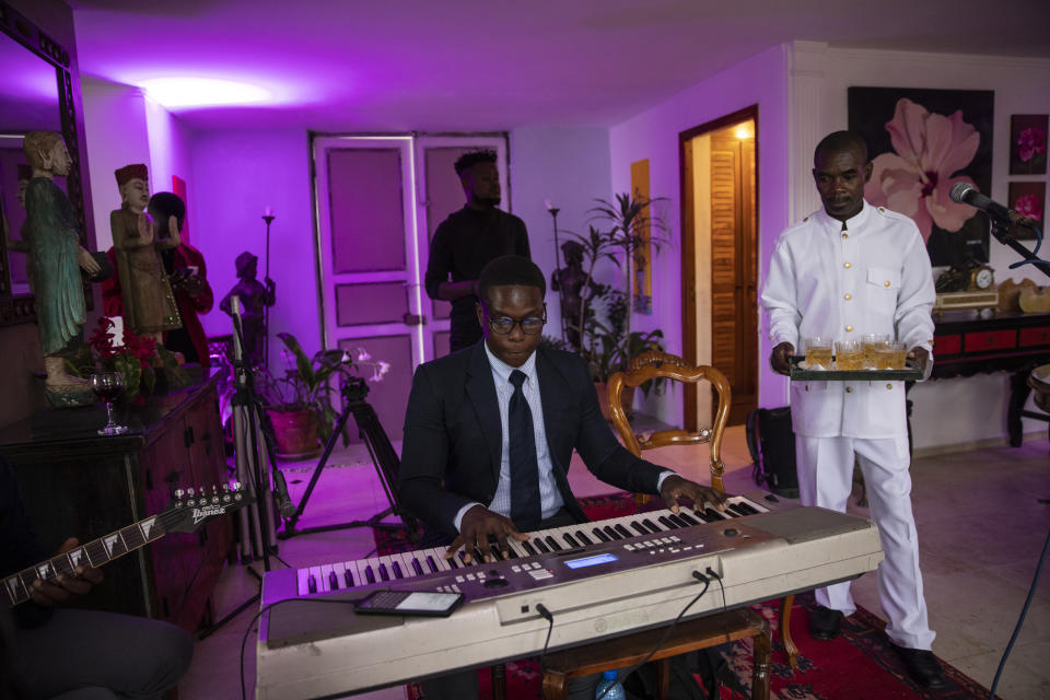 Musicians perform Haitian folkloric music during a birthday celebration for 92-year-old Huguette Mevs, in Port-au-Prince, Haiti, Sunday, Oct. 3, 2021. Huguette Mevs is a member of one of the richest families in Haiti; her daughter Youri owns Shodecosa, Haiti's largest industrial park, which warehouses most of the 93 percent of the nation's food that is imported. (AP Photo/Rodrigo Abd)