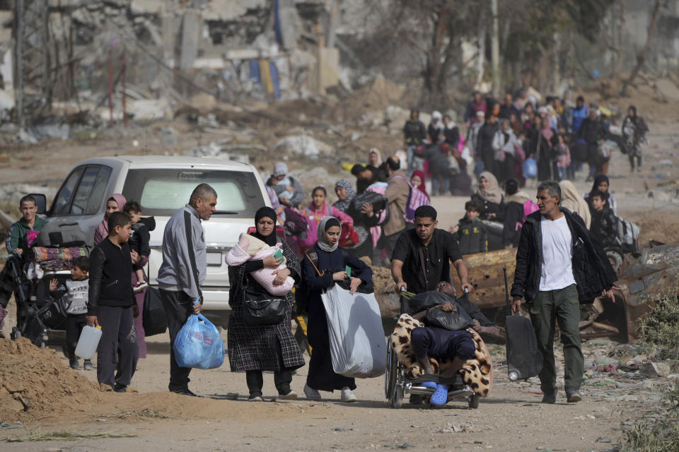 Palestinians flee south on the third day of a cease-fire between Israel and Hamas at Salah al-Din road in central Gaza Strip on Sunday, Nov. 26, 2023. (AP Photo/Hatem Moussa)