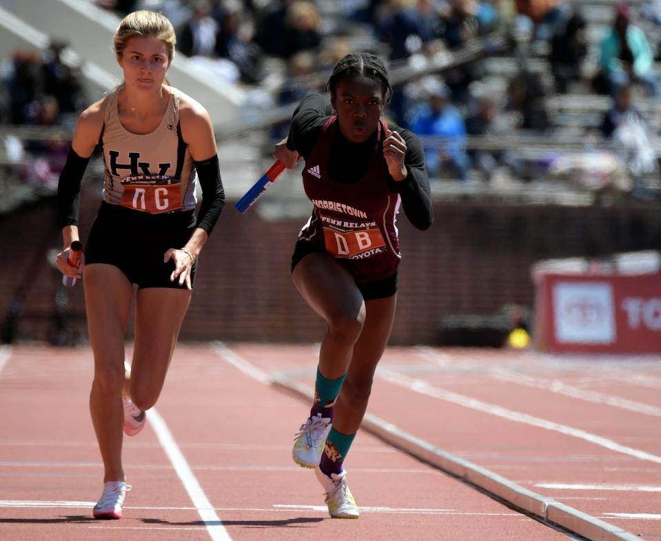 Morristown's Jordan Robinson, right, takes off in a 4x400 relay Thursday, April 28, 2022 at the Penn Relays in Philadelphia, Pa. Morristown placed first in the event.