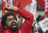 Members of All India Kisan Sangharsh Coordination Committee (AIKSCC) and activists of left parties and trade unions participate in a nationwide protest in Hyderabad, India, Friday, Sept. 25, 2020. Hundreds of Indian farmers took to the streets on Friday protesting new laws that the government says will boost growth in the farming sector through private investments, but they fear these are likely to be exploited by private players for buying their crops cheaply. (AP Photo/Mahesh Kumar A.)