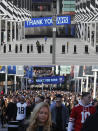 A combo of photos shows fans approaching Wembley Stadium before an NFL football game between the Los Angeles Rams and the Cincinnati Bengals on Sunday, Oct. 27, 2019, in London and an image showing an empty Wembley Way taken on Wednesday, April 1, 2020. (AP Photo/Frank Augstein)