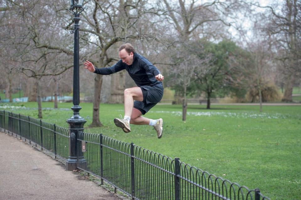 Matt Hancock leaps over a fence during a morning run in St James’s Park (Jeremy Selwyn)