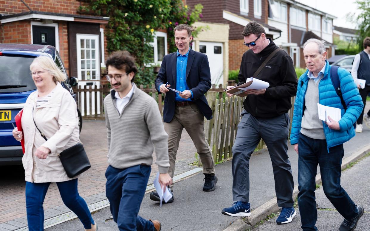 Jeremy Hunt campaigns with his team in his constituency in Surrey