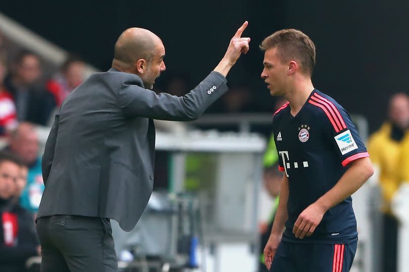 Pep Guardiola, head coach of Bayern Munich, talks to his player Joshua Kimmich during the Bundesliga match between VfB Stuttgart and FC Bayern Muenchen at Mercedes-Benz Arena on April 9, 2016 in Stuttgart, Germany.