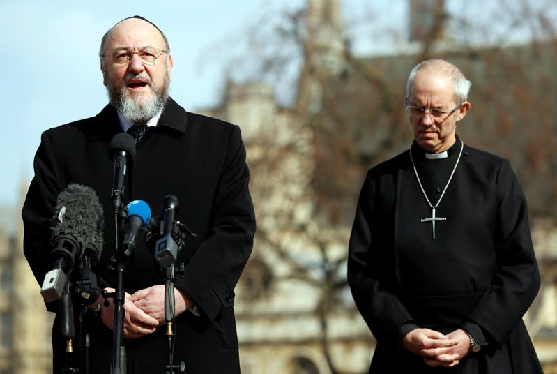 FILE PHOTO: Britain's Archbishop of Canterbury, Justin Welby, listens to the Chief Rabbi, Ephraim Mirvis speak to the media following a recent attack in Westminster, London