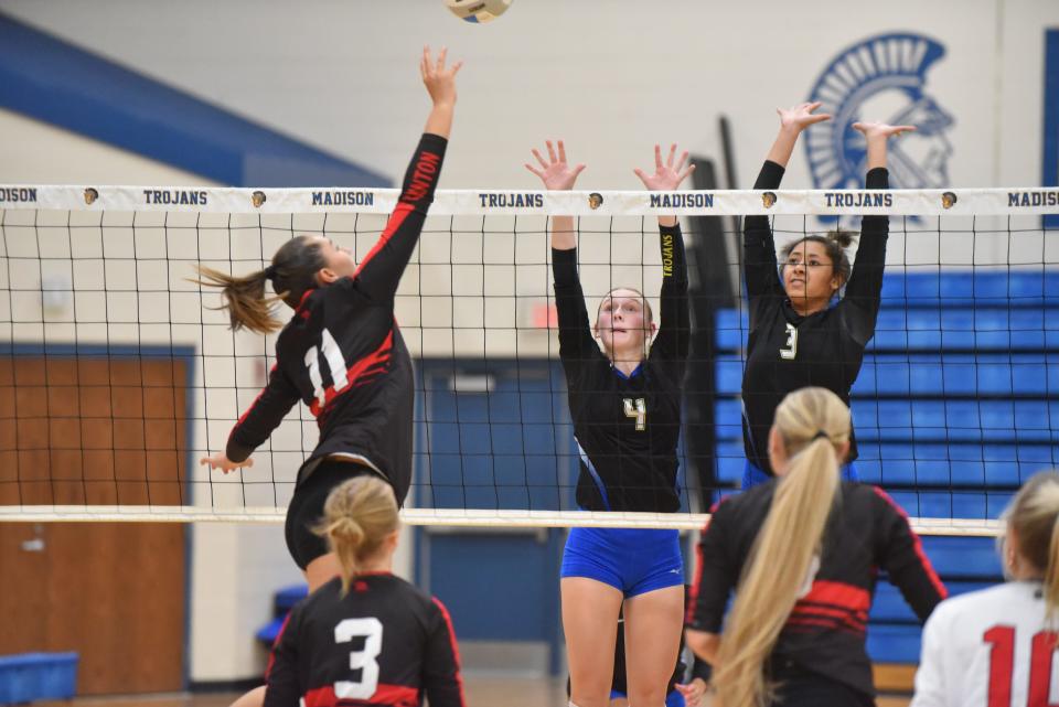 Madison's Jillian Kendrick (4) and Tatum Wilson (3) go up for a block during a match against Clinton.