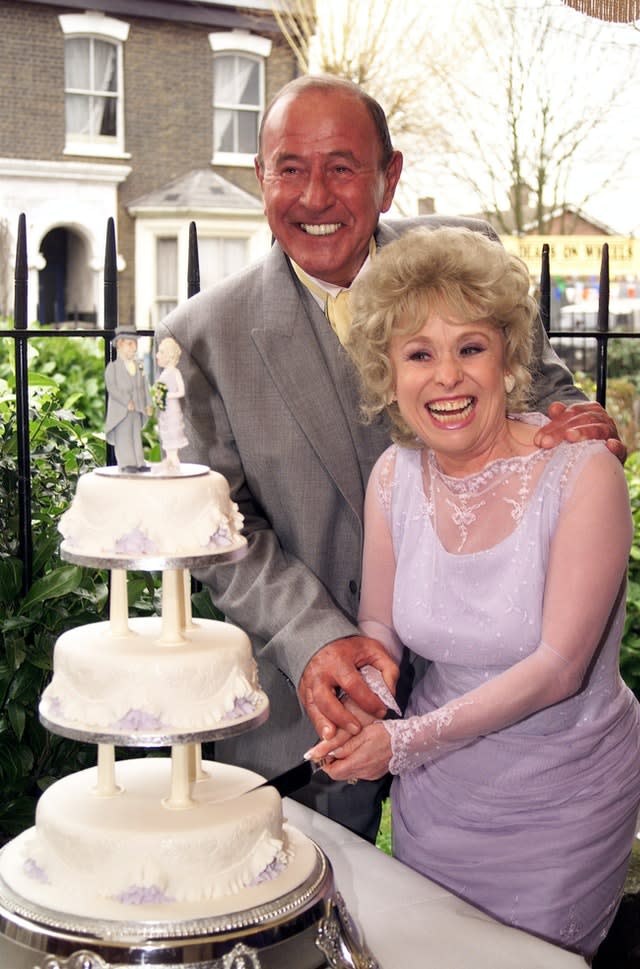 Peggy Mitchell and Frank Butcher (Mike Reid) cutting their cake