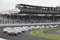 FILE - In this Sept. 8, 2019, file photo, Kevin Harvick leads the field through the first turn on the start of the NASCAR Brickyard 400 auto race at Indianapolis Motor Speedway in Indianapolis. The once frosty schism between the two biggest racing series in the United States has thawed and NASCAR's elite Cup Series will share a venue with IndyCar on the same weekend for the first time in history. (AP Photo/Darron Cummings, File)