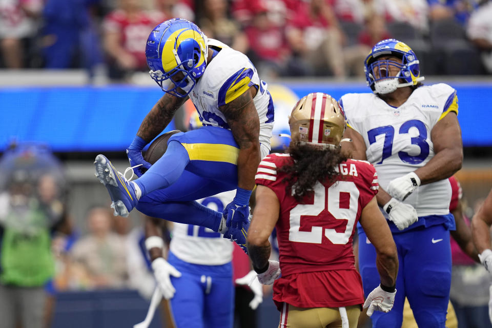 Los Angeles Rams running back Kyren Williams, left, scores a touchdown as guard Steve Avila, right, celebrates and San Francisco 49ers safety Talanoa Hufanga watches during the first half of an NFL football game Sunday, Sept. 17, 2023, in Inglewood, Calif. (AP Photo/Gregory Bull)