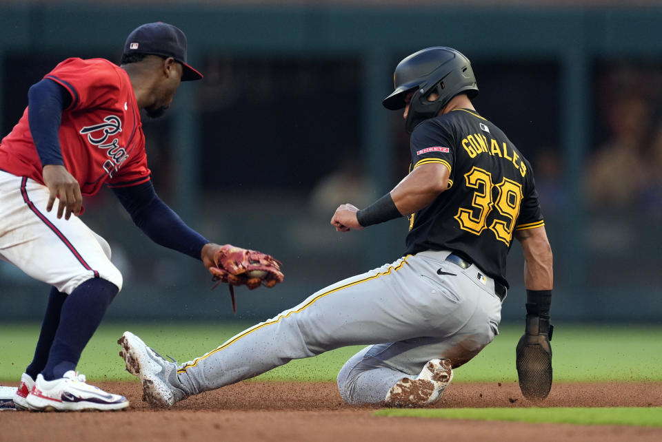 Pittsburgh Pirates' Nick Gonzales (39) steals second base ahead of the throw to Atlanta Braves second baseman Ozzie Albies (1) in the second inning of a baseball game Friday, June 28, 2024, in Atlanta. (AP Photo/John Bazemore)