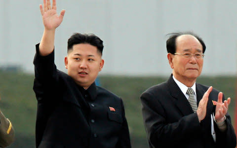  Kim Jong-un, with Kim Yong-nam - Credit: AP