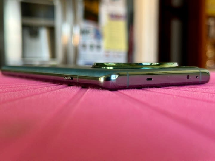 OnePlus 12 in Flowy Emerald showing flat top edge.