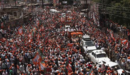 Hindu nationalist Narendra Modi, prime ministerial candidate for India's main opposition Bharatiya Janata Party (BJP), waves to his supporters as he arrives to file his nomination papers for the general elections in the northern Indian city of Varanasi April 24, 2014. REUTERS/Adnan Abidi