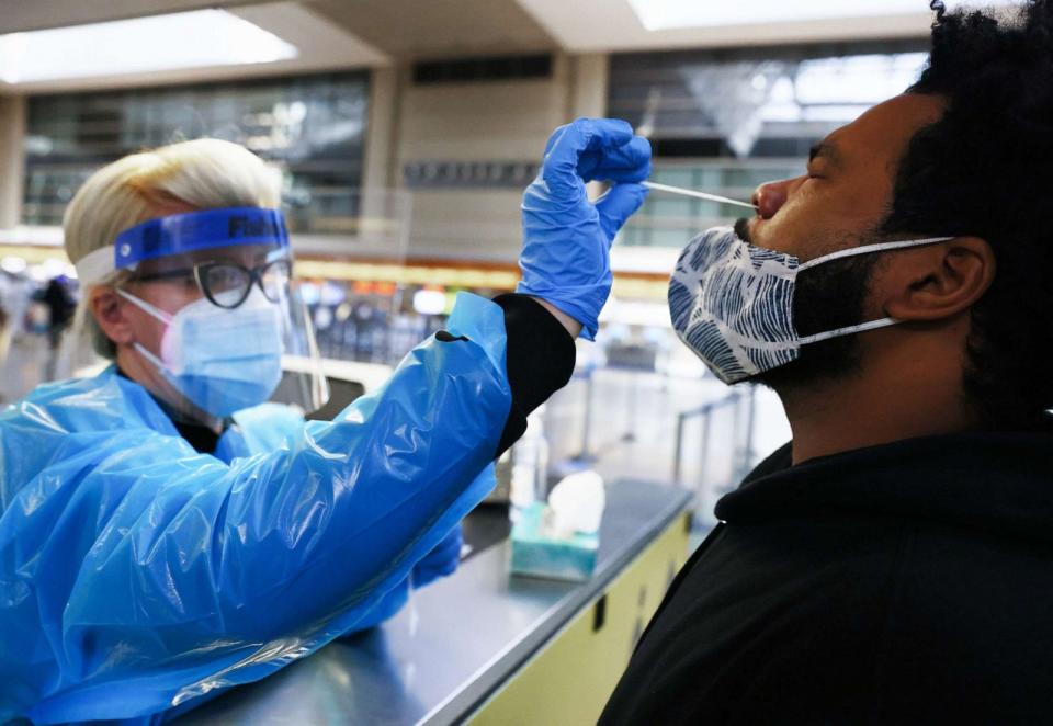 PHOTO: A man receives a nasal swab COVID-19 test at Tom Bradley International Terminal at Los Angeles International Airport (LAX) amid a coronavirus surge in Southern California, Dec. 22, 2020, in Los Angeles. (Mario Tama/Getty Images)