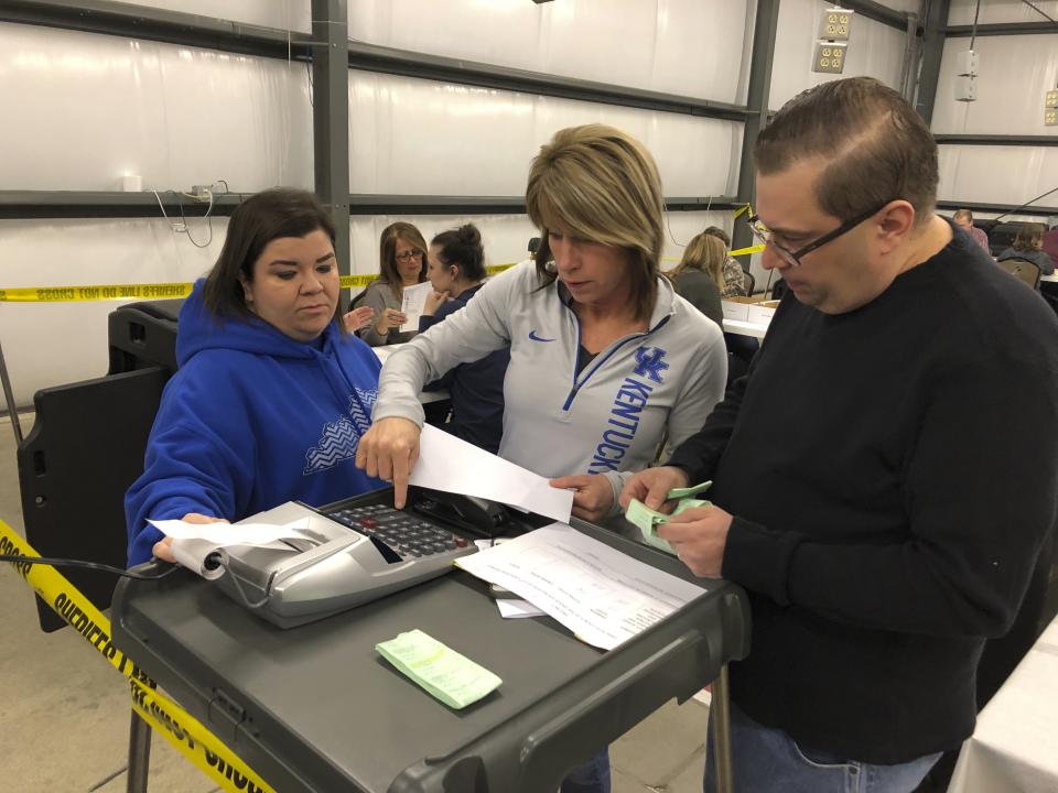 From right, Daviess County Chief Deputy Clerk Richard House and deputy clerks Tonya Payne and Kelli Shively review vote totals during a recount of Kentucky House district 13 on Saturday, Feb. 2, 2019, in Owensboro, Ky. Democrat Jim Glenn won the race by one vote in November. But the Republican-controlled legislature ordered a recount at the request of GOP candidate DJ Johnson. (AP Photo/Adam Beam)