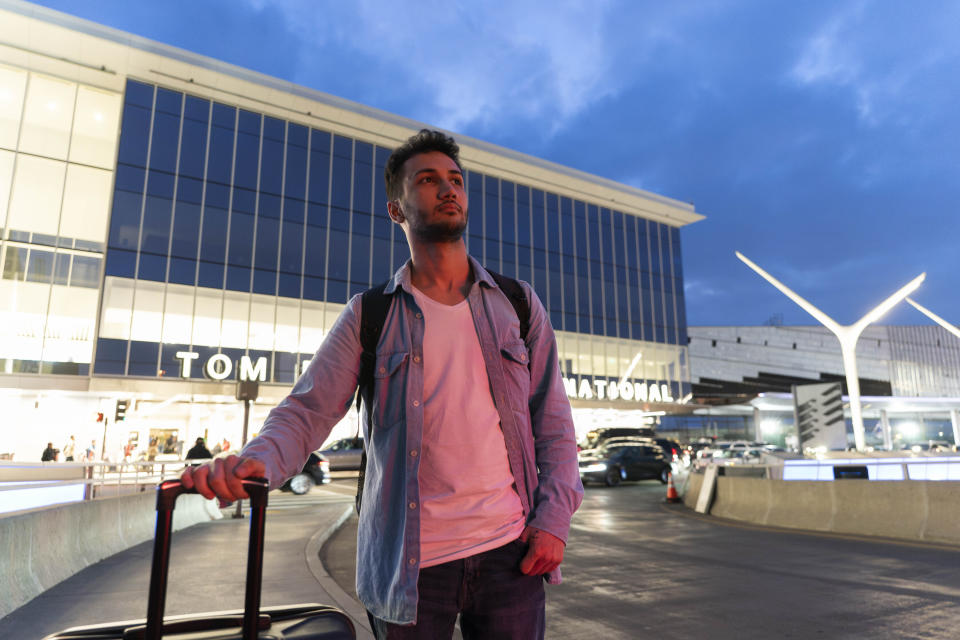 Iranian political activist Mahdi Vatankhah pauses for photos at the Los Angeles International Airport in Los Angeles, Thursday, June 1, 2023. Vatankhah, while in custody and after his release, helped Michael White, a Navy veteran who was jailed in Iran for several years on spying charges, by providing White's mother with crucial, firsthand accounts about her son's status in prison and by passing along letters White had written while he was locked up. Once freed, White did not forget. He pushed successfully this year for Vatankhah's admission to the United States, allowing the men to be reunited last spring, something neither could have envisioned when they first met in prison years earlier. (AP Photo/Jae C. Hong)