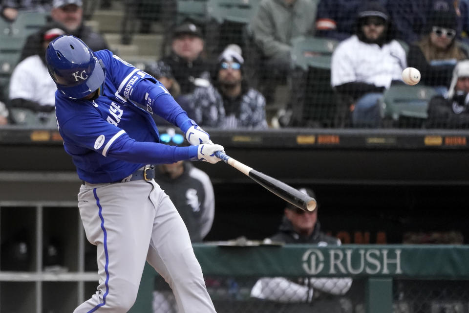Kansas City Royals' Whit Merrifield hits a sacrifice fly off Chicago White Sox relief pitcher Bennett Sousa during the seventh inning of a baseball game Wednesday, April 27, 2022, in Chicago. (AP Photo/Charles Rex Arbogast)