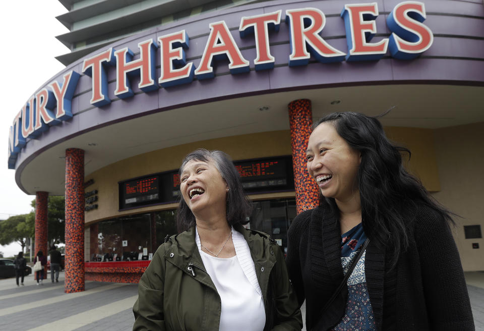 In this Thursday, Aug. 23, 2018 photo, Alice Sue, left, and her daughter Audrey Sue-Matsumoto laugh while interviewed after watching the movie Crazy Rich Asians in Daly City, Calif. It was Sue's second time watching the movie. When "Crazy Rich Asians" surpassed expectations and grabbed the top spot in its opening weekend, the film also pulled off another surprising feat. It put Asians of a certain age in theater seats. (AP Photo/Jeff Chiu)