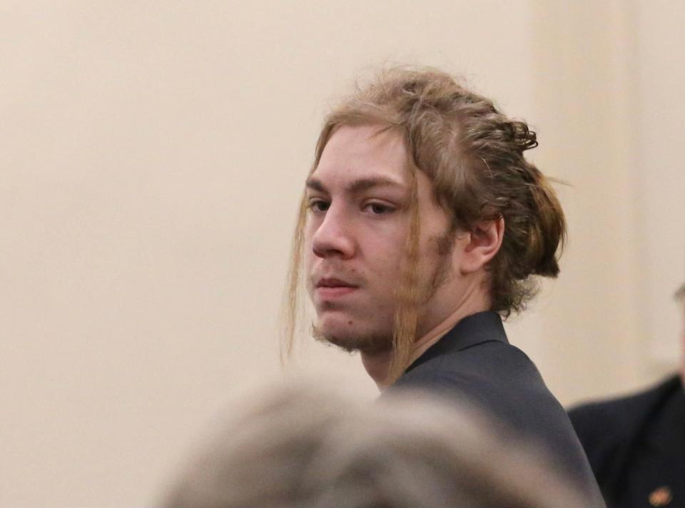 Andrew Huber Young, 19, looks back at family members Friday, Juy 29, 2022 in York County Superior Court in Alfred, Maine. Huber Young is charged with murder in the shooting death of his 22-month-old niece, Octavia Huber Young.