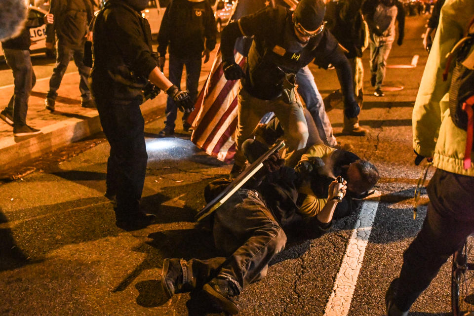 Members of the Proud Boys kick a member of Antifa on the ground during a protest on December 12, 2020 in Washington, DC. (Stephanie Keith/Getty Images)