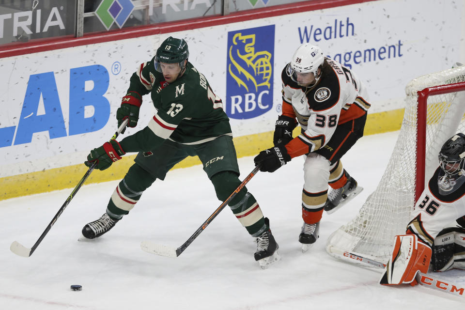 Minnesota Wild's Nick Bonino (13) controls the puck against Anaheim Ducks' Derek Grant (38) during the first period of an NHL hockey game Friday, May 7, 2021, in St. Paul, Minn. (AP Photo/Stacy Bengs)