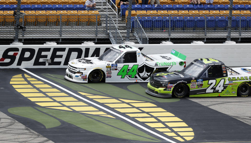 Ross Chastain (44) leads Brett Moffitt (24) during a restart in a NASCAR Truck Series auto race, Sunday, June 16, 2019, at Iowa Speedway in Newton, Iowa. (AP Photo/Charlie Neibergall)