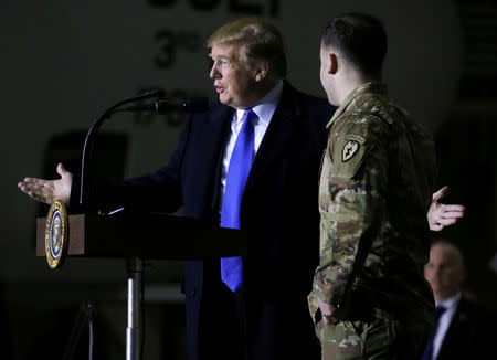 FILE PHOTO: U.S. President Donald Trump introduces U.S. Army Bronze Star recipient Sgt. Sean Rogers after calling him onstage while addressing members of the military during a refueling stop at Elmendorf Air Force Base in Anchorage, Alaska, U.S., February 28, 2019. REUTERS/Leah Millis/File Photo