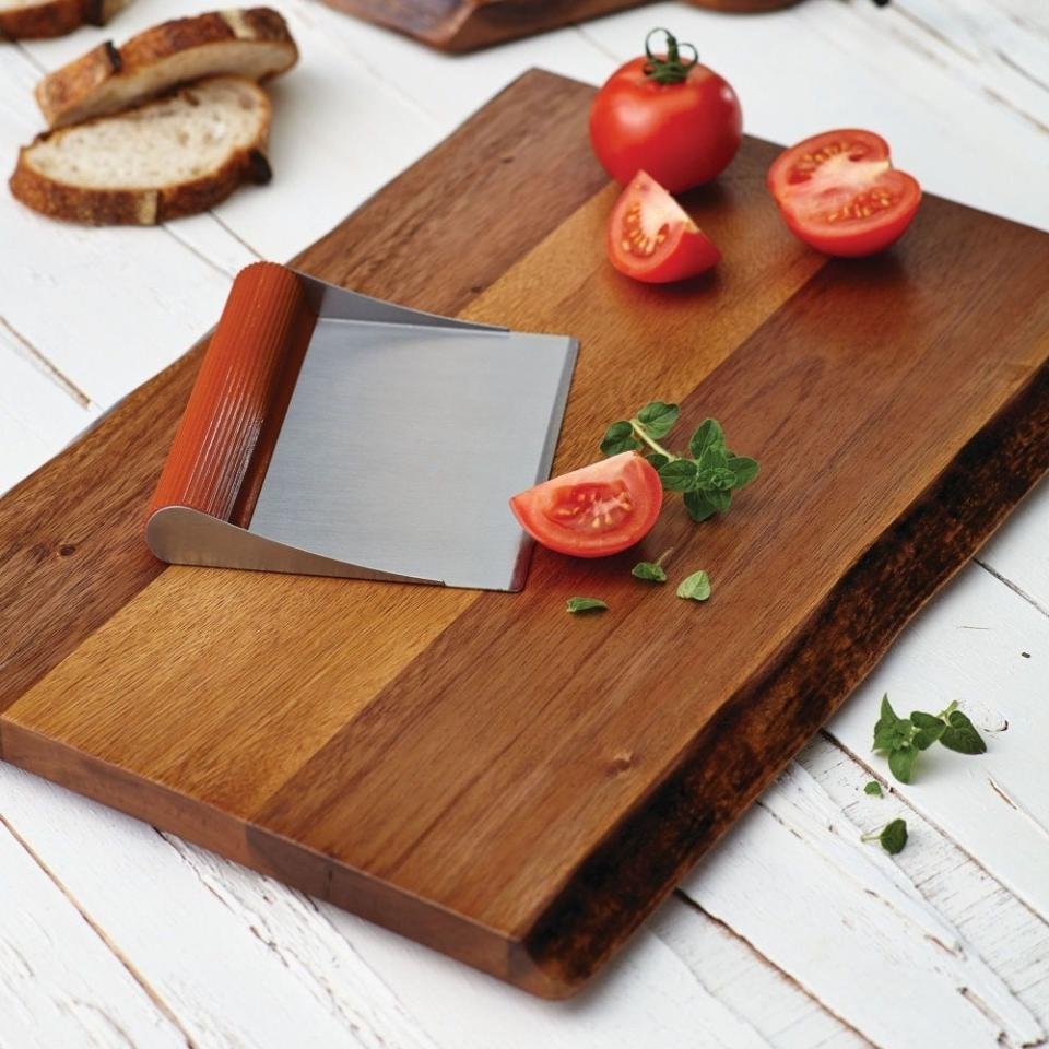 wooden cutting board with sliced tomato and bread