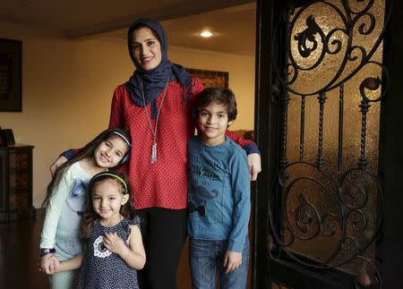 Mirvette Judeh poses a photo with her children, Ayah Maaytah (L-R), 7, Salma Maaytah, 3, and Rakan Maaytah, 9, at their home in Buena Park, California December 17, 2015. REUTERS/Jason Redmond