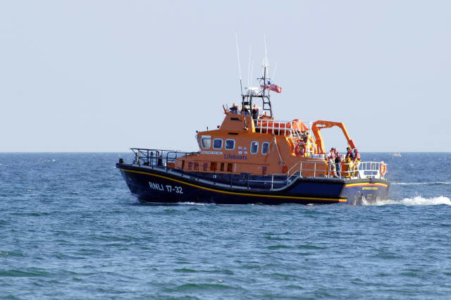 An RNLI All Weather off shore Lifeboat in Weymouth bay out on a search and rescue mission