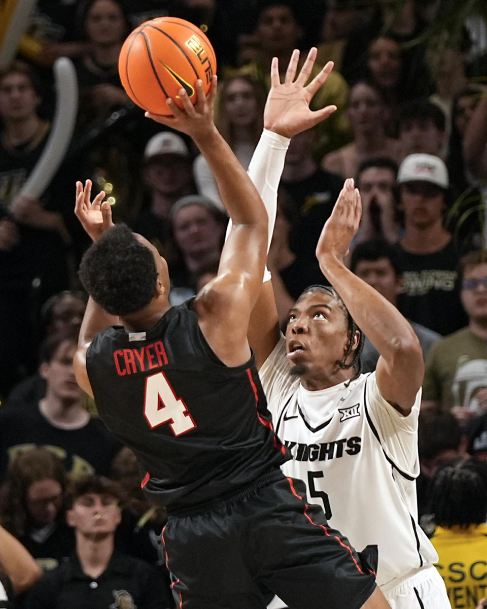 Houston guard L.J. Cryer (4) shoots over Central Florida forward Omar Payne (5) during the second half of an NCAA college basketball game Wednesday, March 6, 2024, in Orlando, Fla. (AP Photo/John Raoux)