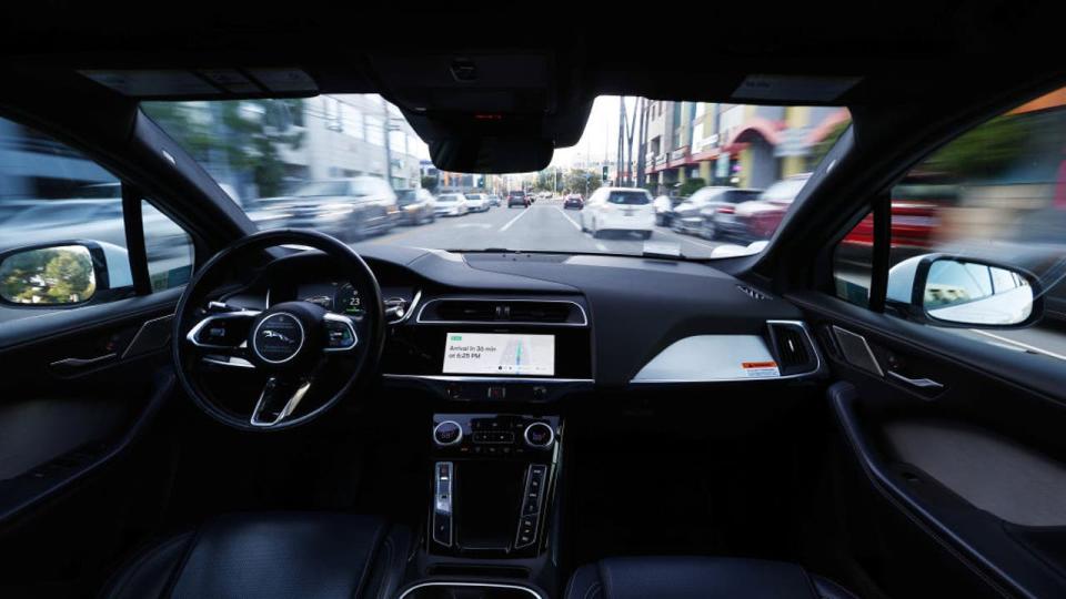 <div>A Waymo autonomous self-driving Jaguar taxi drives along a street on March 14, 2024 in Los Angeles, California.</div>