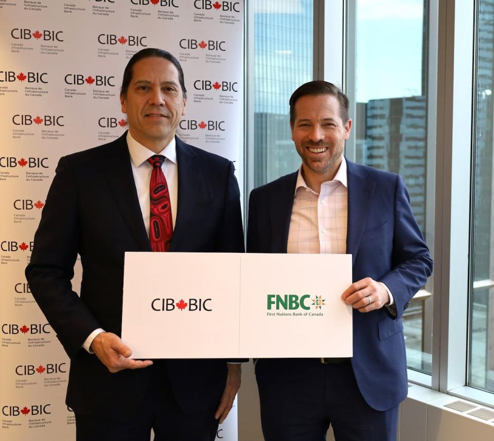 FNBC CEO Bill Lomax (left) and CIB CEO Ehren Cory are pictured in a photo handout, as part of their respective banks announcing a partnership. (Submitted by Canada Infrastructure Bank - image credit)