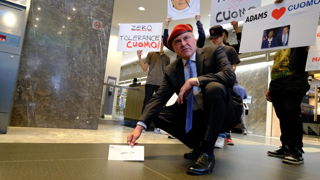 Republican New York City mayoral candidate Curtis Sliwa posing with a letter to New York Gov. Cuomo demanding his resignation.