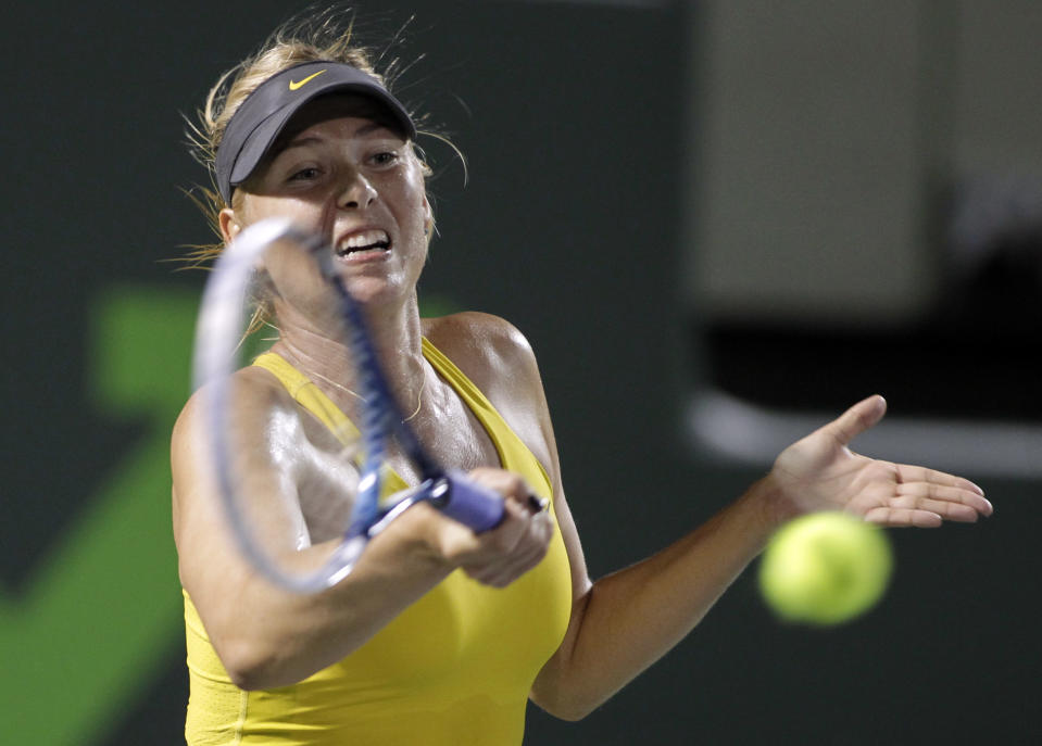 Maria Sharapova, of Russia, returns the ball to Kurumi Nara, of Japan, during a match at the Sony Open tennis tournament, Thursday, March 20, 2014, in Key Biscayne, Fla. (AP Photo/Luis M. Alvarez)