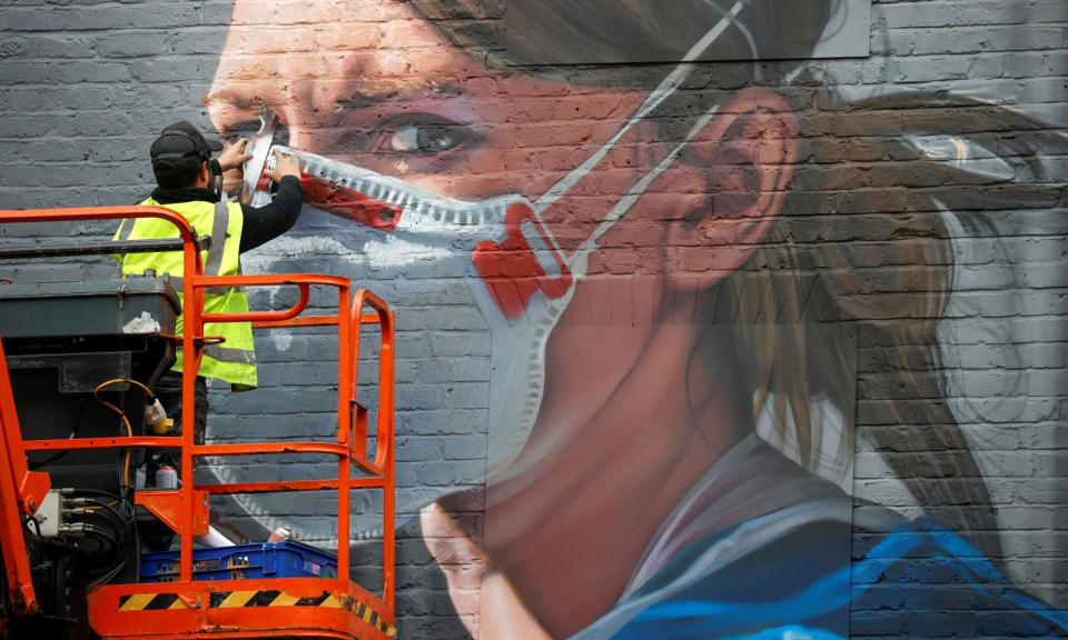 <span>An artist works on a mural during the coronavirus pandemic in Manchester. Some scientists believe Sars-Cov-2 remains a threat.</span><span>Photograph: Phil Noble/Reuters</span>