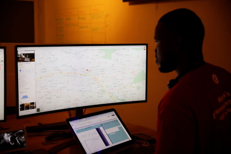 A dispatcher for the Rescue.org free ambulance service looks at a computer screen during the coronavirus night curfew in Nairobi