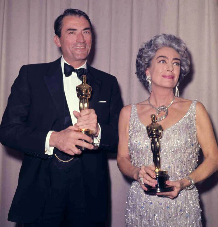 Gregory Peck and Joan Crawford backstage at the Oscars.