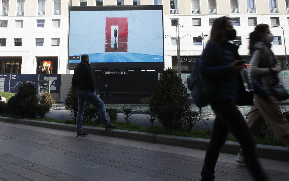 A giant screen streams a Prada fashion live show during the women's Fall Winter 2021-22 collection, unveiled during the Fashion Week in Milan, Italy, Thursday, Feb. 25, 2021. (AP Photo/Antonio Calanni)