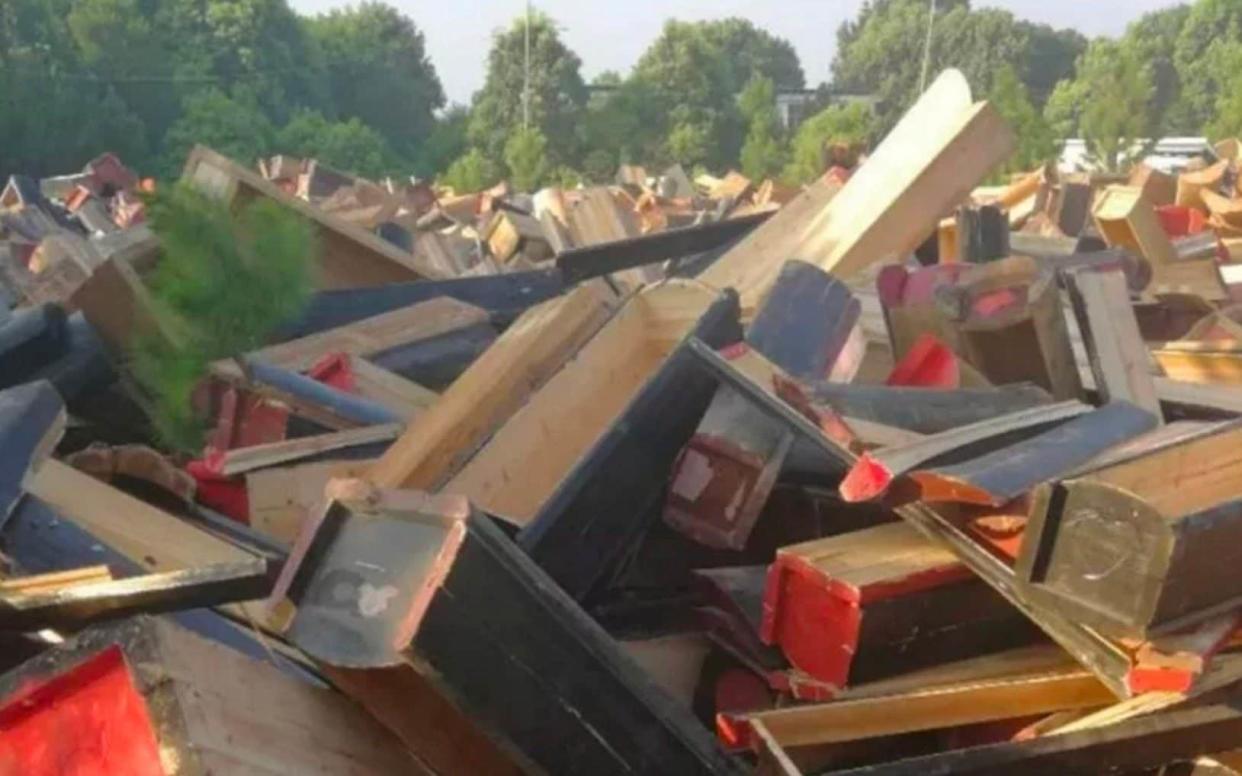 Authorities took coffins from villagers’ homes, piled them up in extraordinary scenes and then had them destroyed