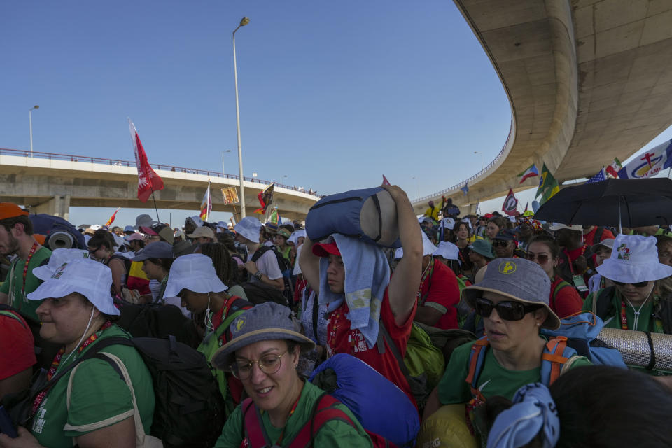 Pilgrims leave Parque Tejo in Lisbon where Pope Francis presided over a mass celebrating the 37th World Youth Day, Sunday, Aug. 6, 2023. An estimated 1.5 million young people filled the parque on Saturday for Pope Francis' World Youth Day vigil, braving scorching heat to secure a spot for the evening prayer and to camp out overnight for his final farewell Mass on Sunday morning. (AP Photo/Ana Brigida)