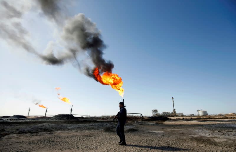 FILE PHOTO: A policeman is seen at West Qurna-1 oil field, which is operated by ExxonMobil, in Basra