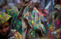 <p>Widows daubed in colours dance as they take part in Holi celebrations in the town of Vrindavan in the northern state of Uttar Pradesh, India, Feb. 27, 2018. (Photo: Adnan Abidi/Reuters) </p>