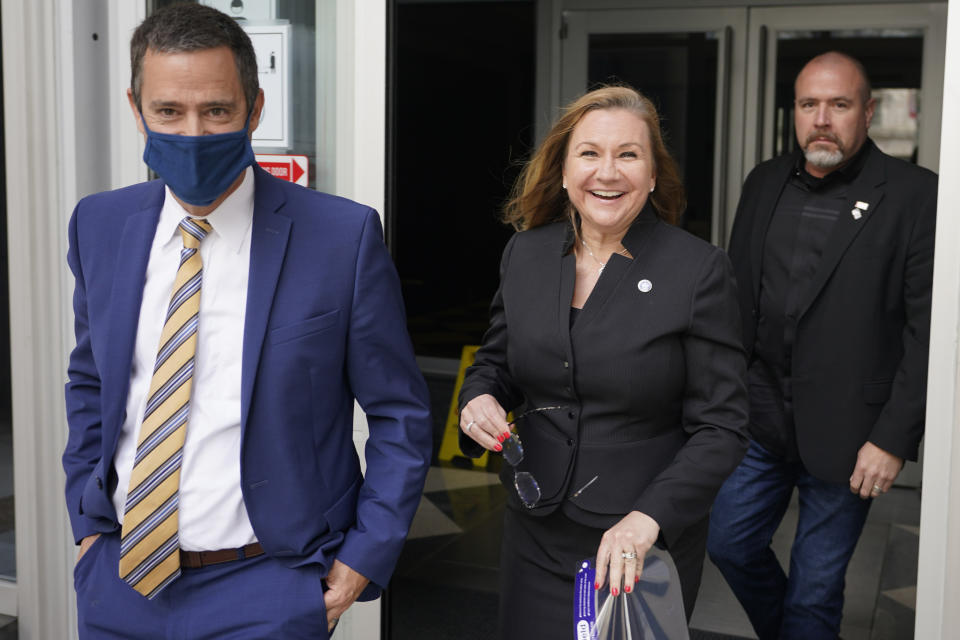 Virginia State Sen. Amanda Chase, R-Chesterfield, center, leaves court with her attorney Tim Anderson, left, during a break in a hearing to dismiss here lawsuit in Federal court in Richmond, Va., Thursday, April 1, 2021. (AP Photo/Steve Helber)