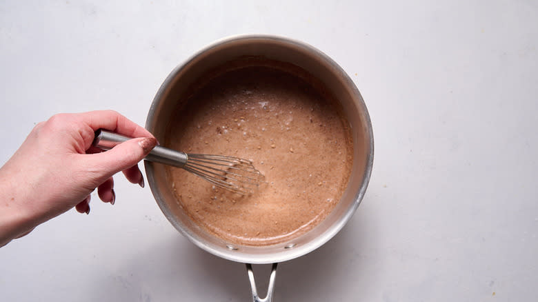 whisking ingredients in saucepan