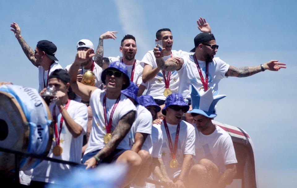 Lionel Messi and teammates celebrate on the bus before being forced to abandon the parade (Reuters)