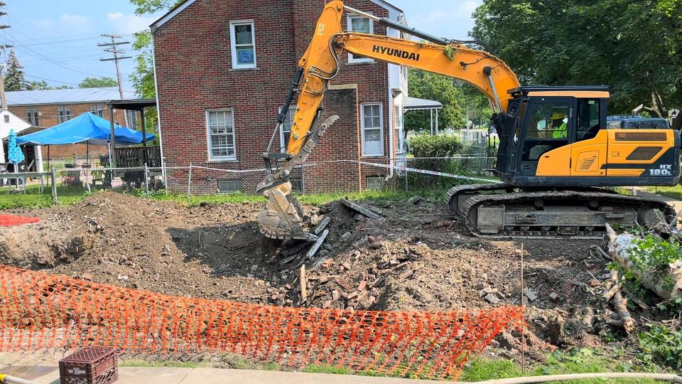 Crews work to demolish an abandoned home on Eastlawn Street in Detroit, Mi on July 20, 2021. Georgia Taylor fought for seven years to get the abandoned home next door demolished and she now owns the lot.