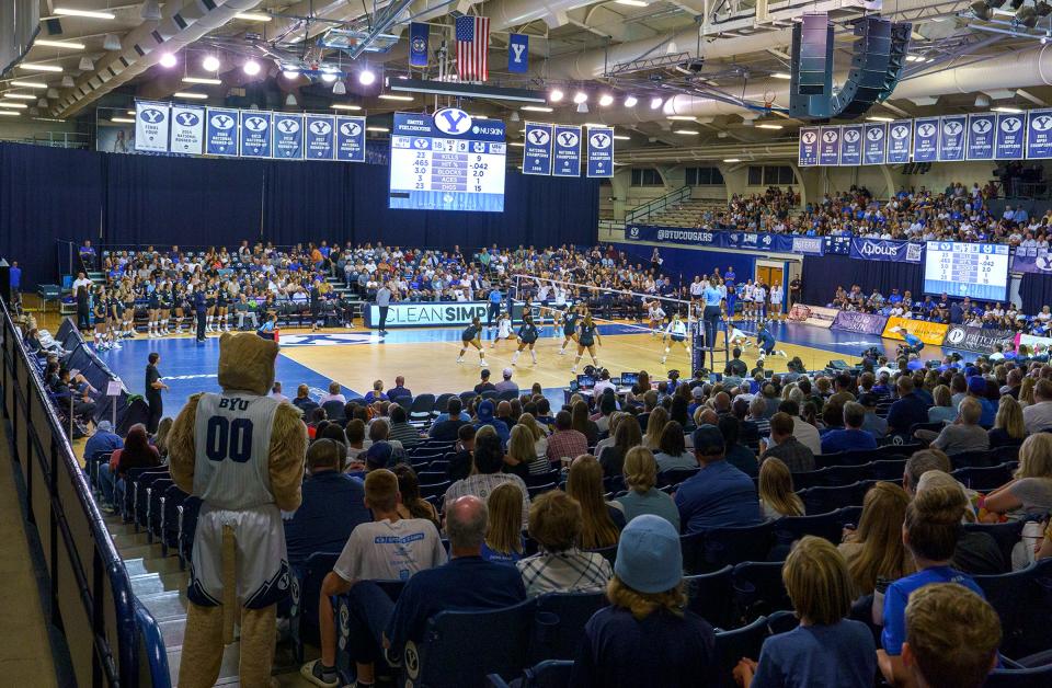 Fans cheer during an NCAA college volleyball game between BYU and Utah State in Provo, Utah, on Sept. 1.